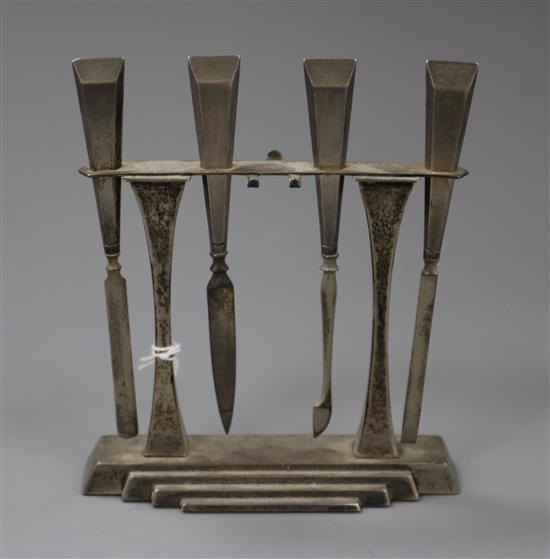 An Art Deco silver four piece manicure set and stand, Crisford & Norris, Birmingham, 1936 (items missing), 11.7cm.